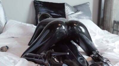 Latex Catsuit in bed on femdomerotic.com