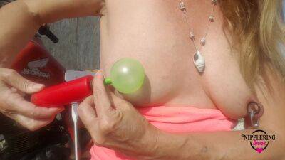 Nippleringlover Horny Milf Sticking Balloons Through Extreme Stretched Pierced Nipples Outdoors on femdomerotic.com