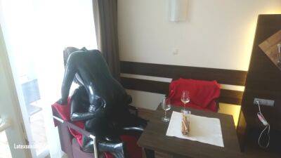 In Latex Covered Couple Enjoys A Good Drink on femdomerotic.com
