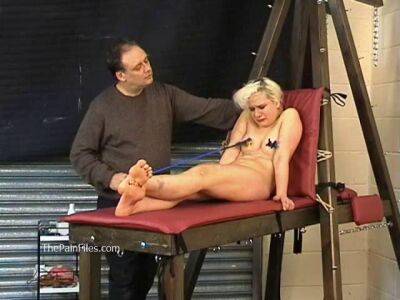 Busty blonde is punished with hot wax and hard spanking on femdomerotic.com